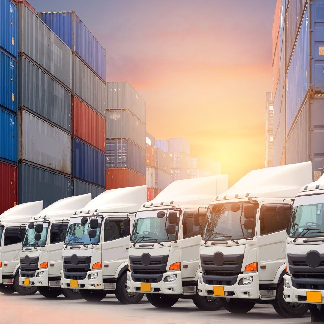 White trucks parked in front on cargo containers